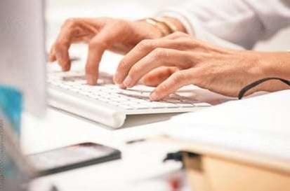 Man typing on computer keyboard
