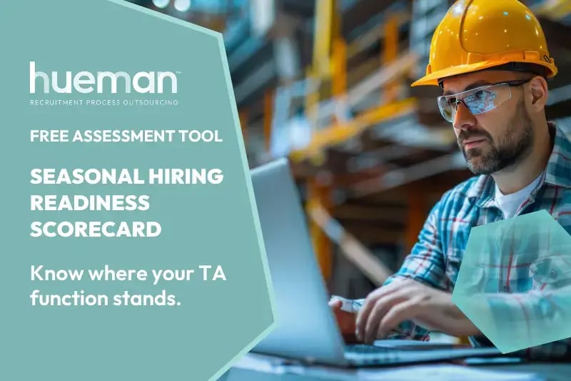 man in hard hat working on laptop