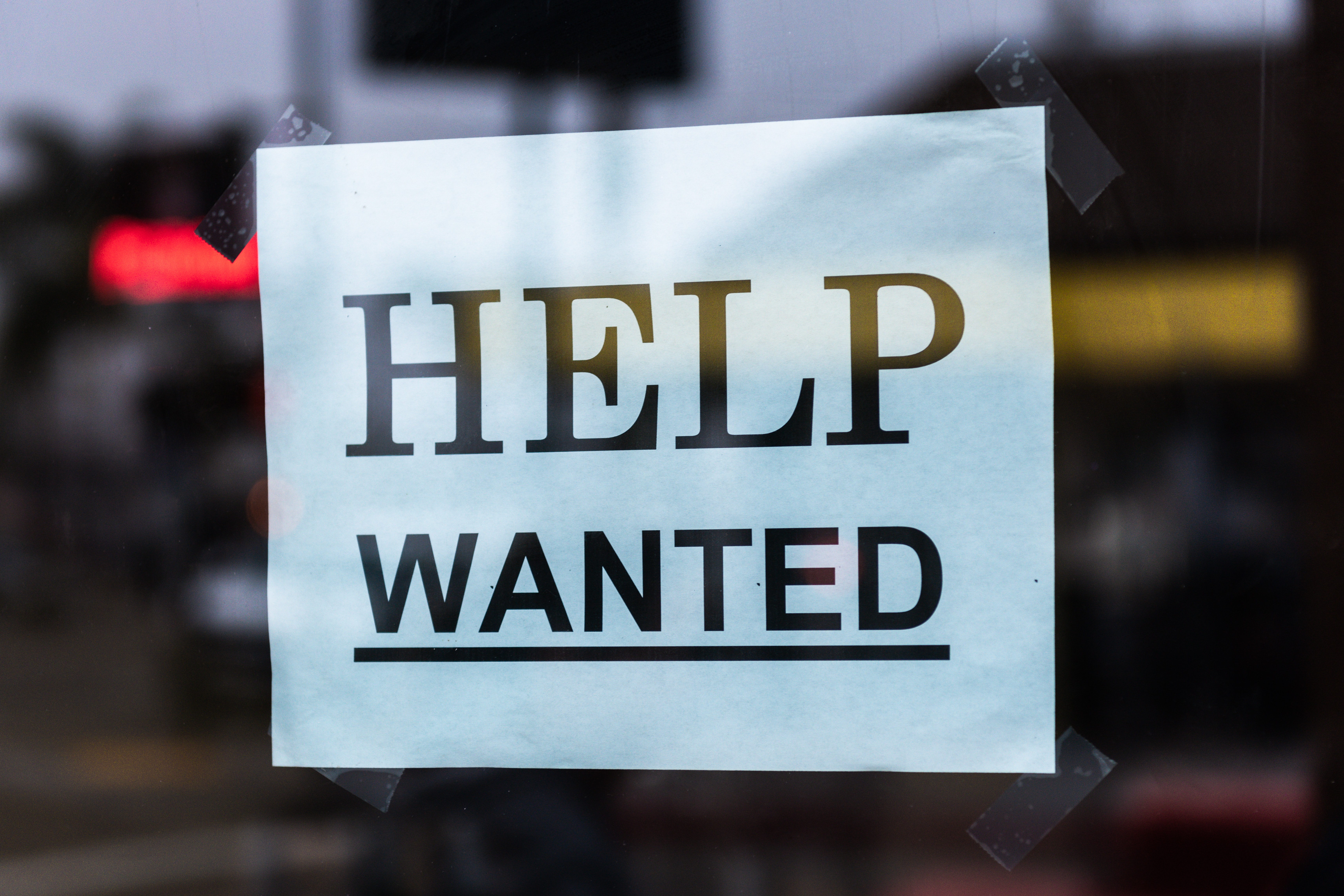 A help wanted sign representing the need to attract and retain recruiters