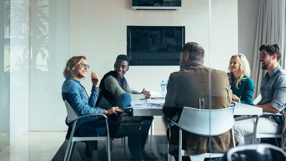 People in a business meeting discussing the top ten benefits of RPO