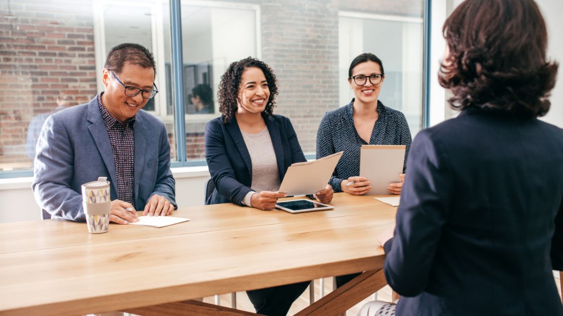 People conducting an employer interview at a table