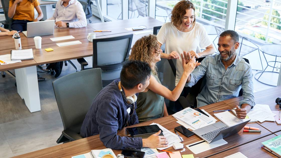 Coworkers chatting at their desk