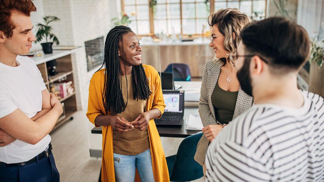 Happy, satisfied employees working together productively in an office setting.