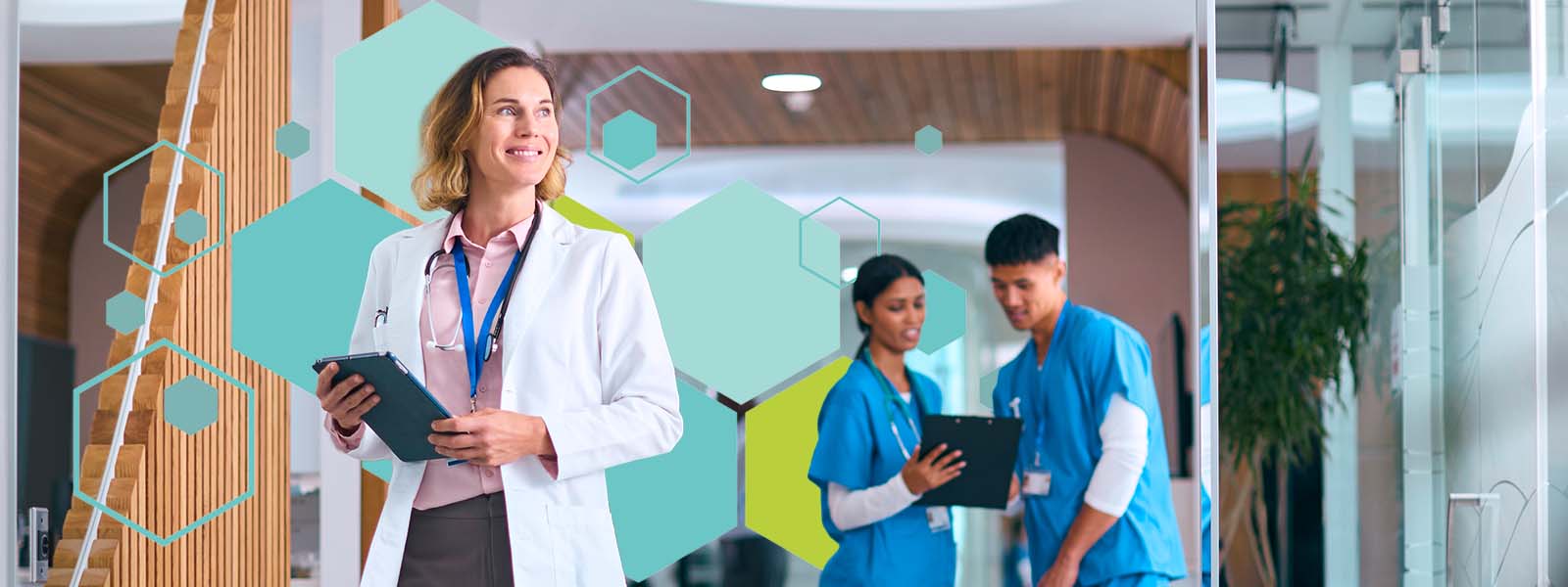 A doctor holding a tablet and smiling while medical staff review notes in a modern hospital, representing collaboration and innovation in healthcare recruitment.
