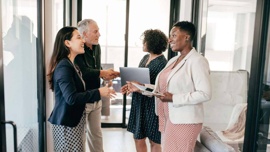 Diverse group of employees welcoming a new team member