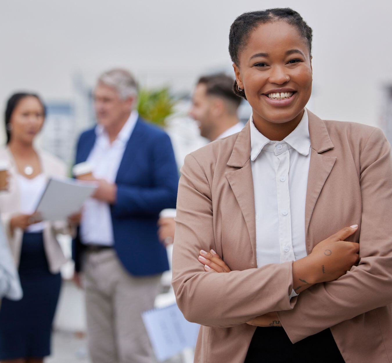 A smiling recruiter with arms crossed