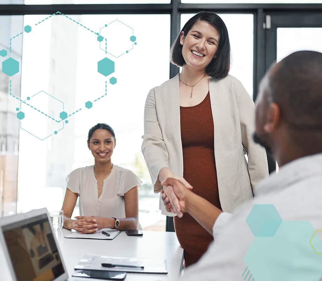 Recruiter from an RPO hiring team greeting a job candidate in a modern office during the recruiting process.