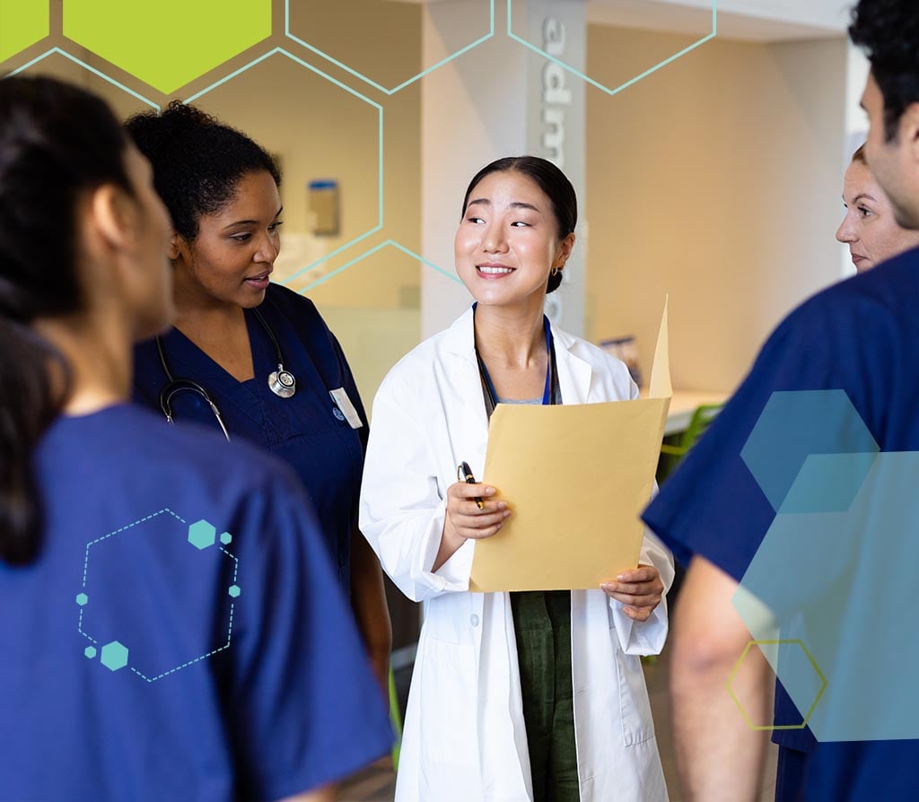 Smiling healthcare professional collaborating in recruitment meeting with folder in hand