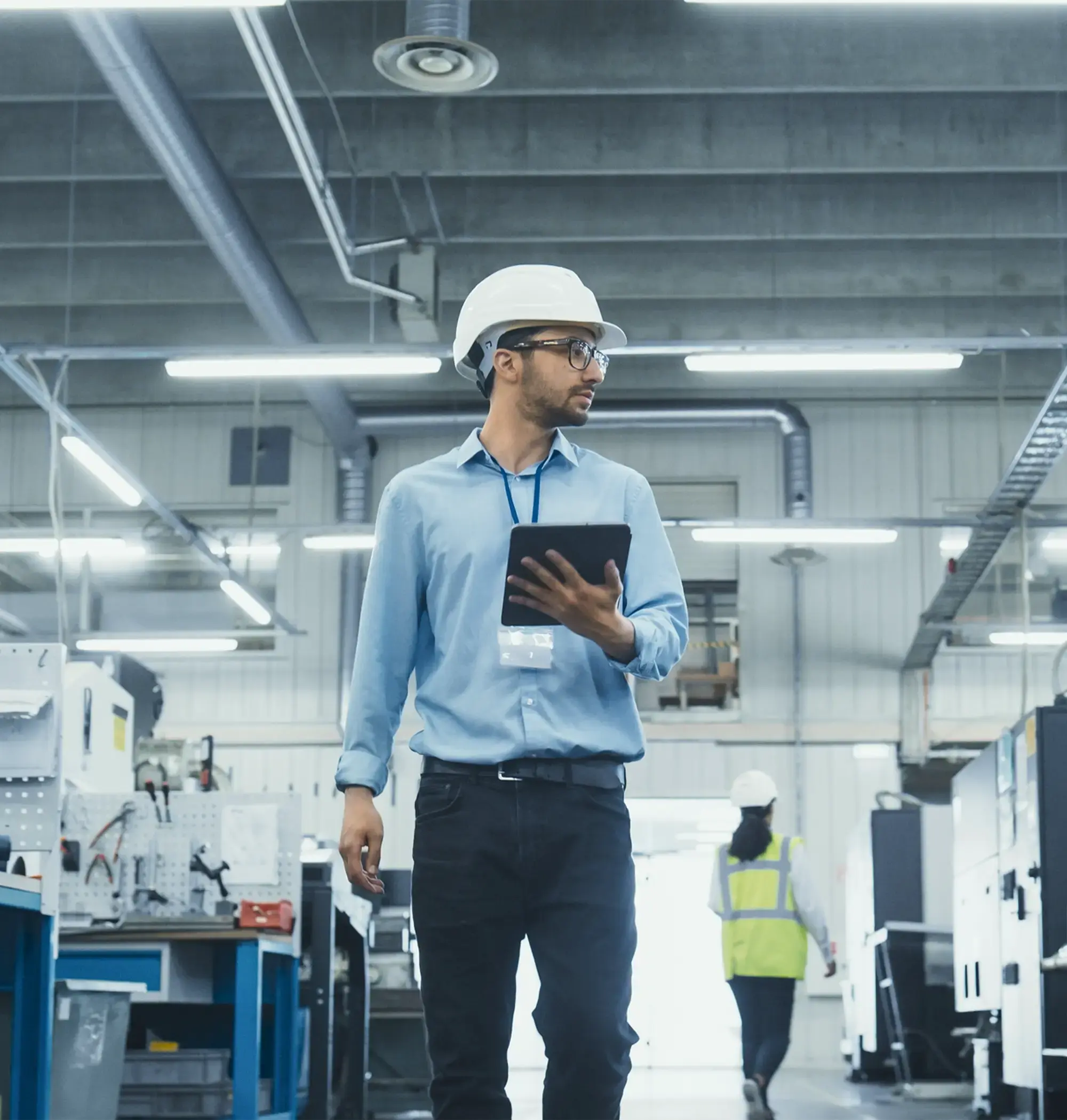 tech executive working in factory.