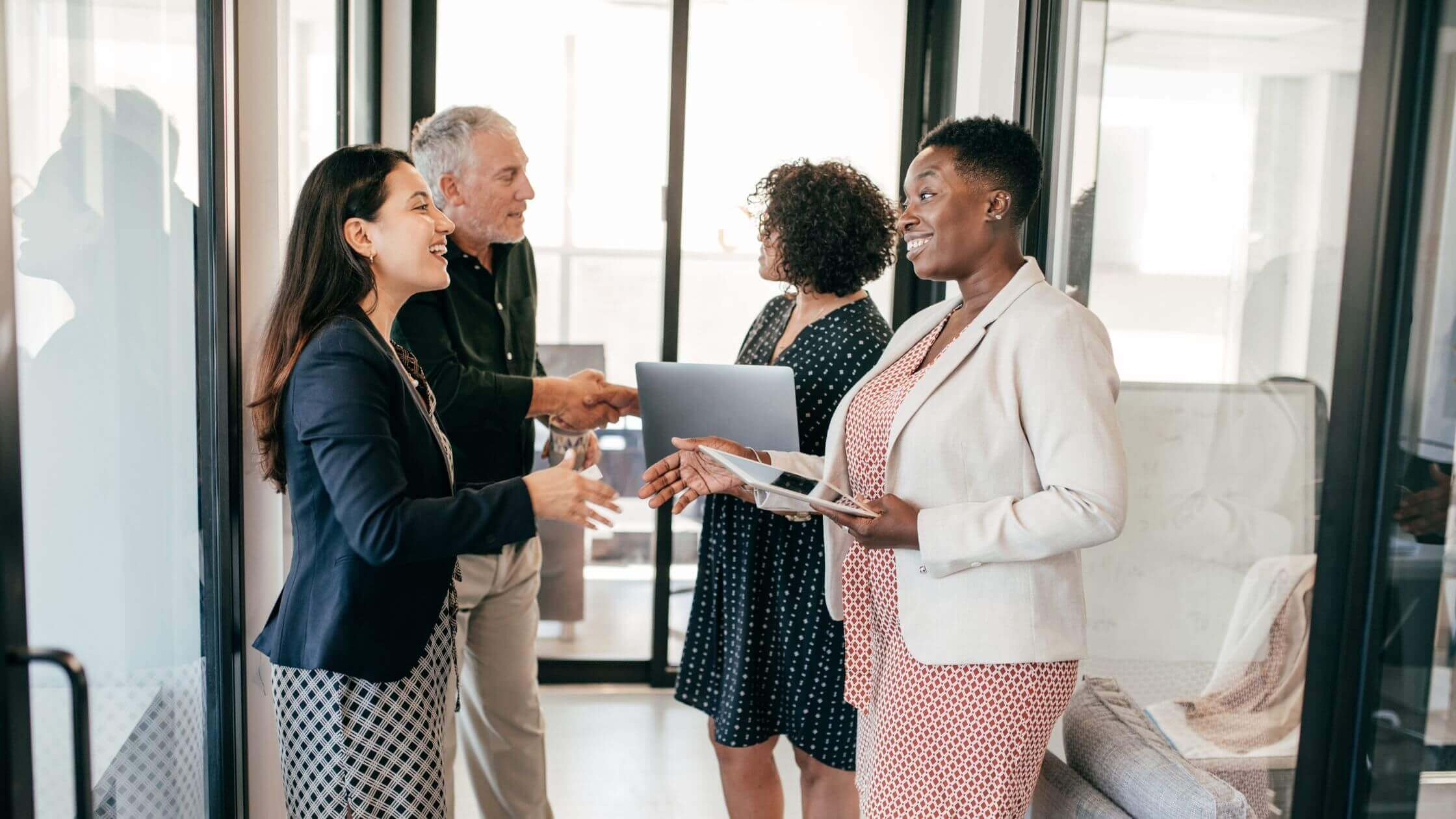 An RPO recruiting team working with their clients at the end of a meeting.