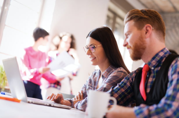 stock-image-man-and-woman-looking-at-laptop