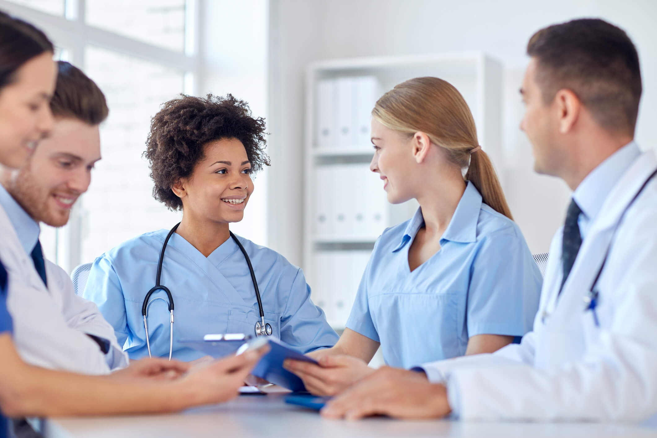 Full-time nurses meeting in a white office