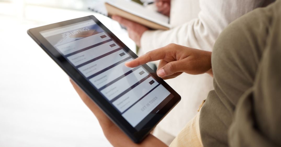 A person using a recruitment app on a tablet