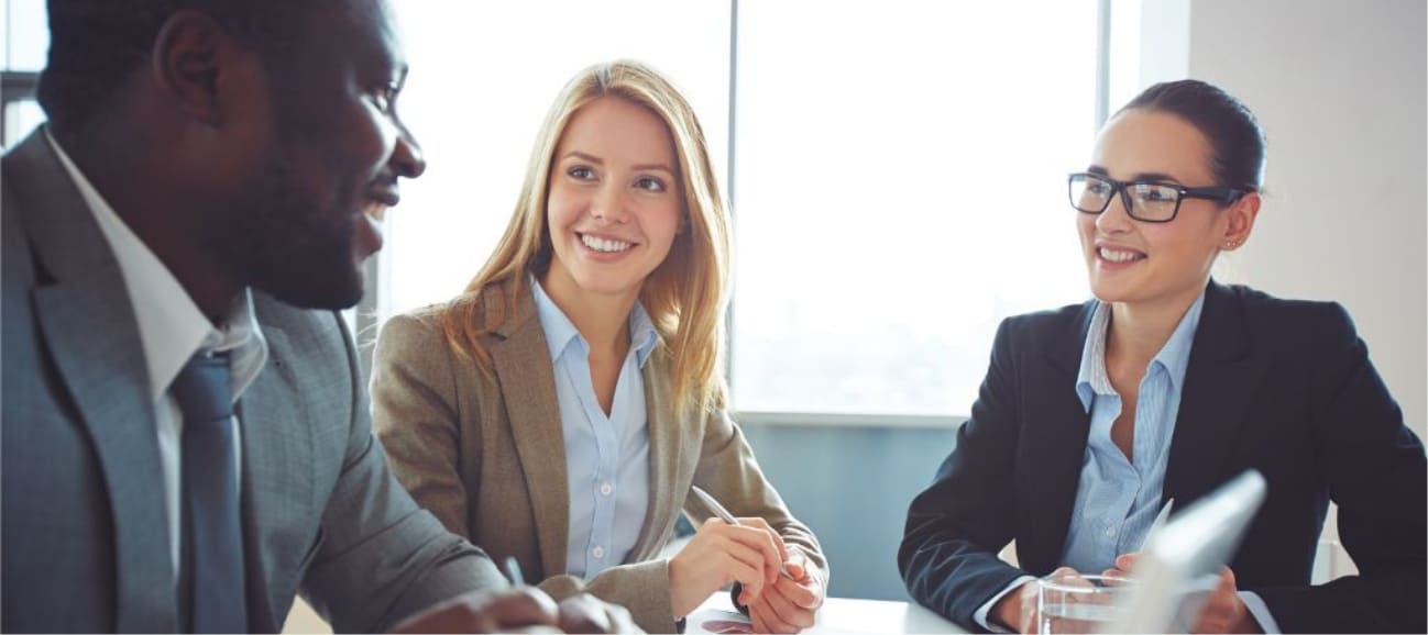 Business professionals at a table discussing RPO solutions